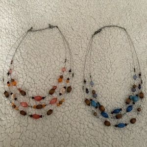 Two beaded necklaces, three strands each. Blue with brown and pink with brown.